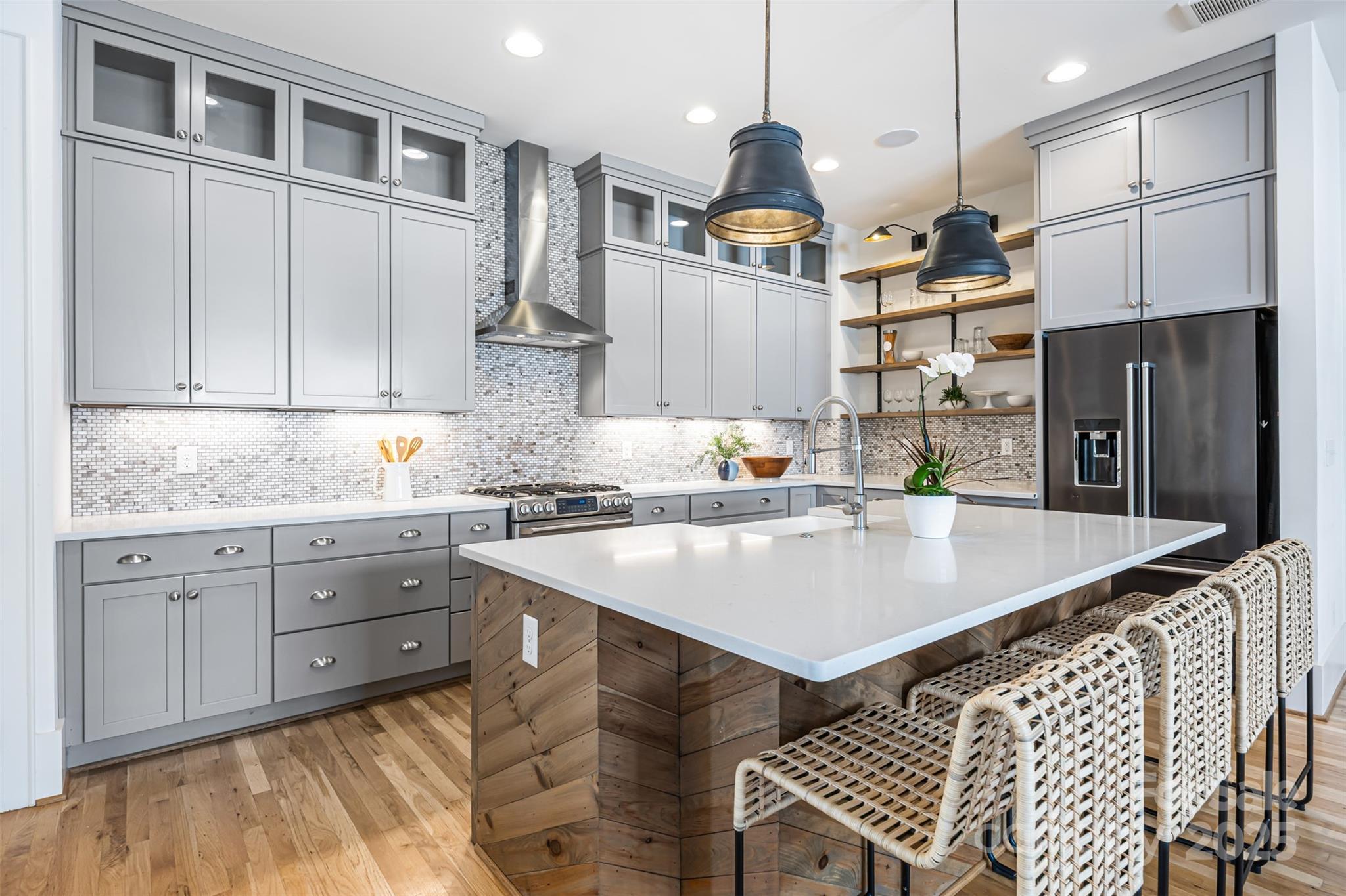 135 Inspired Way Fort Mill, SC 29708 - Photo 13 of 48 a kitchen with stainless steel appliances granite countertop a sink a stove and a refrigerator