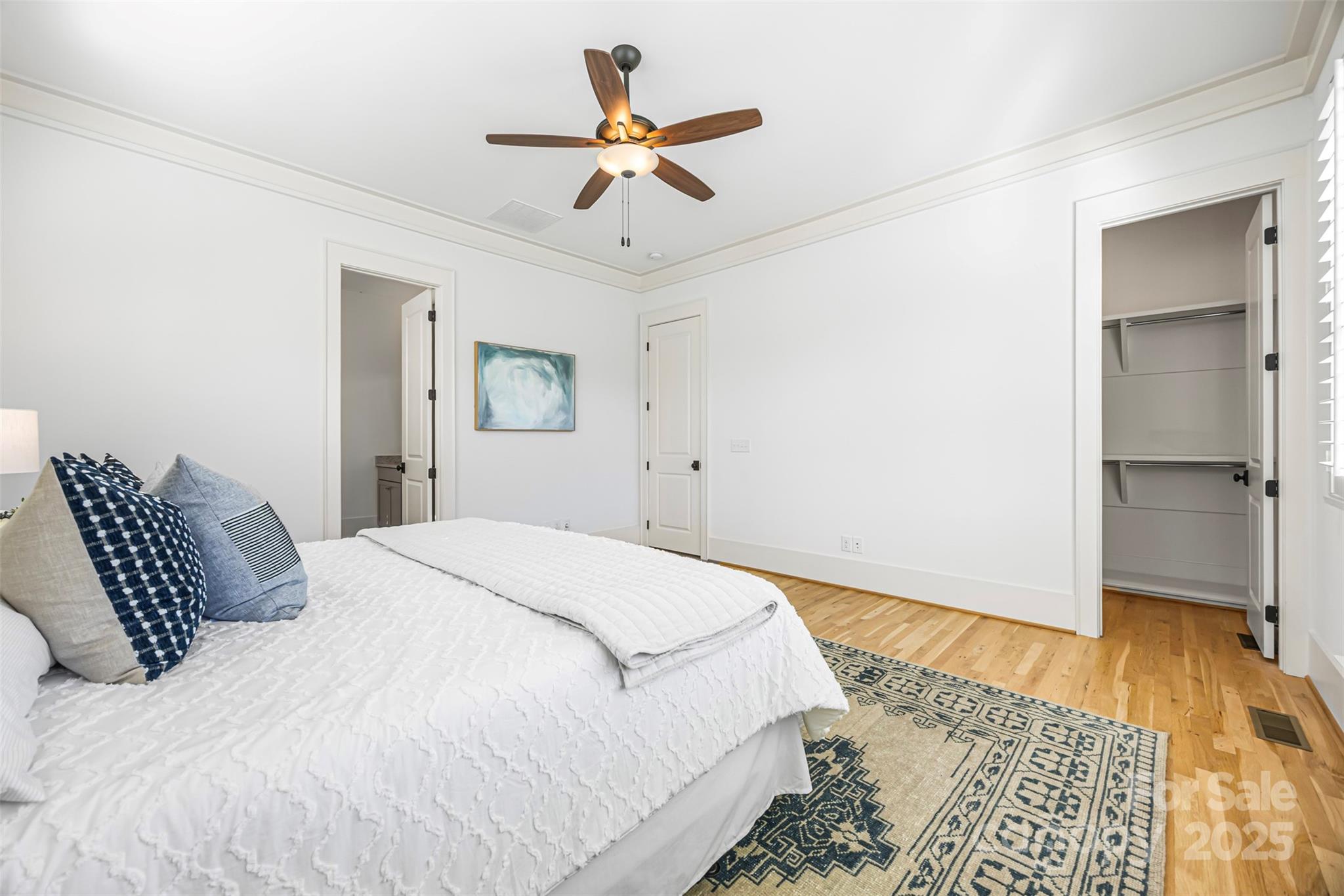 135 Inspired Way Fort Mill, SC 29708 - Photo 19 of 48 a bedroom with a large bed and a chandelier