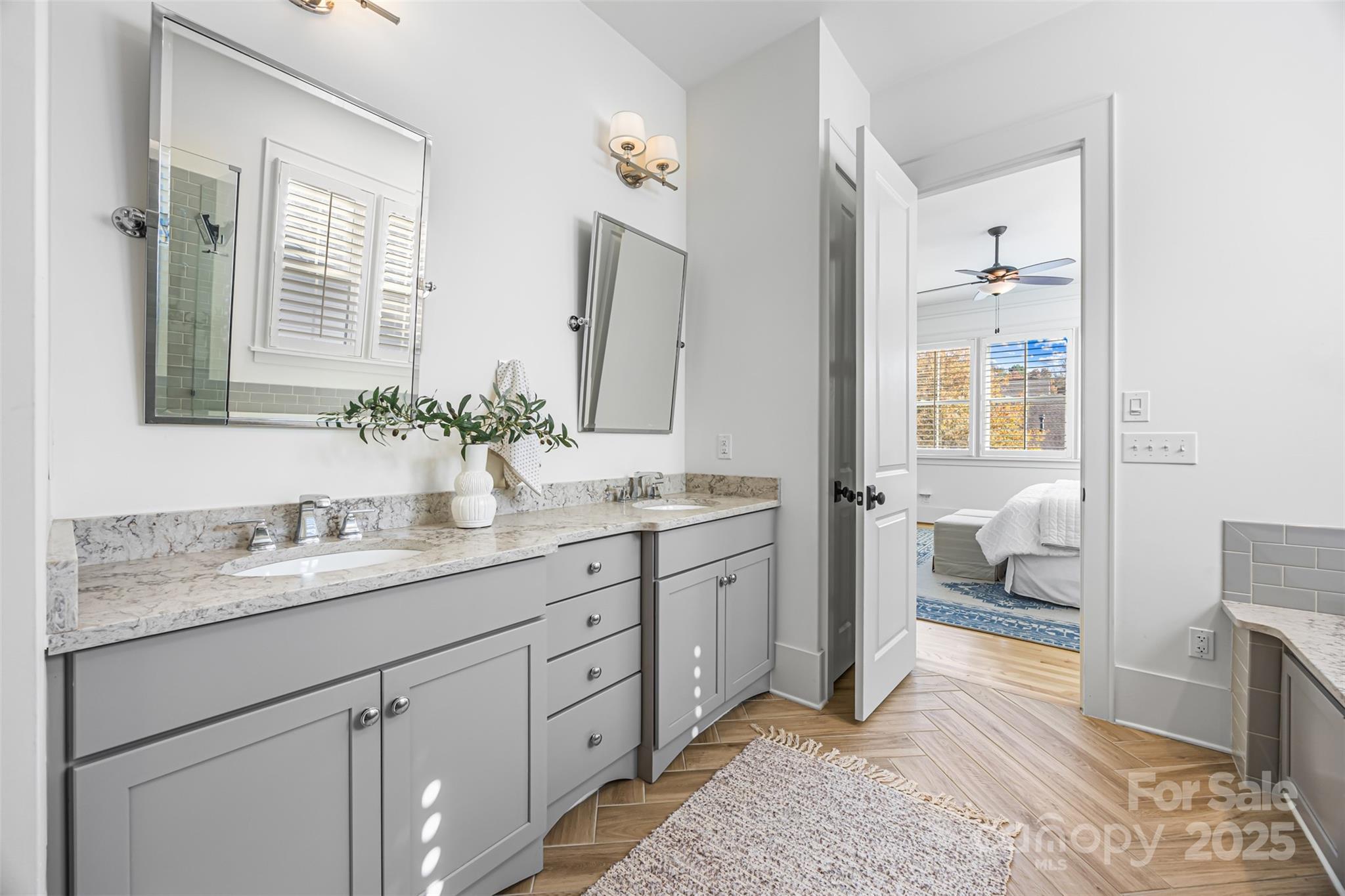 135 Inspired Way Fort Mill, SC 29708 - Photo 20 of 48 a spacious bathroom with a granite countertop sink and a mirror