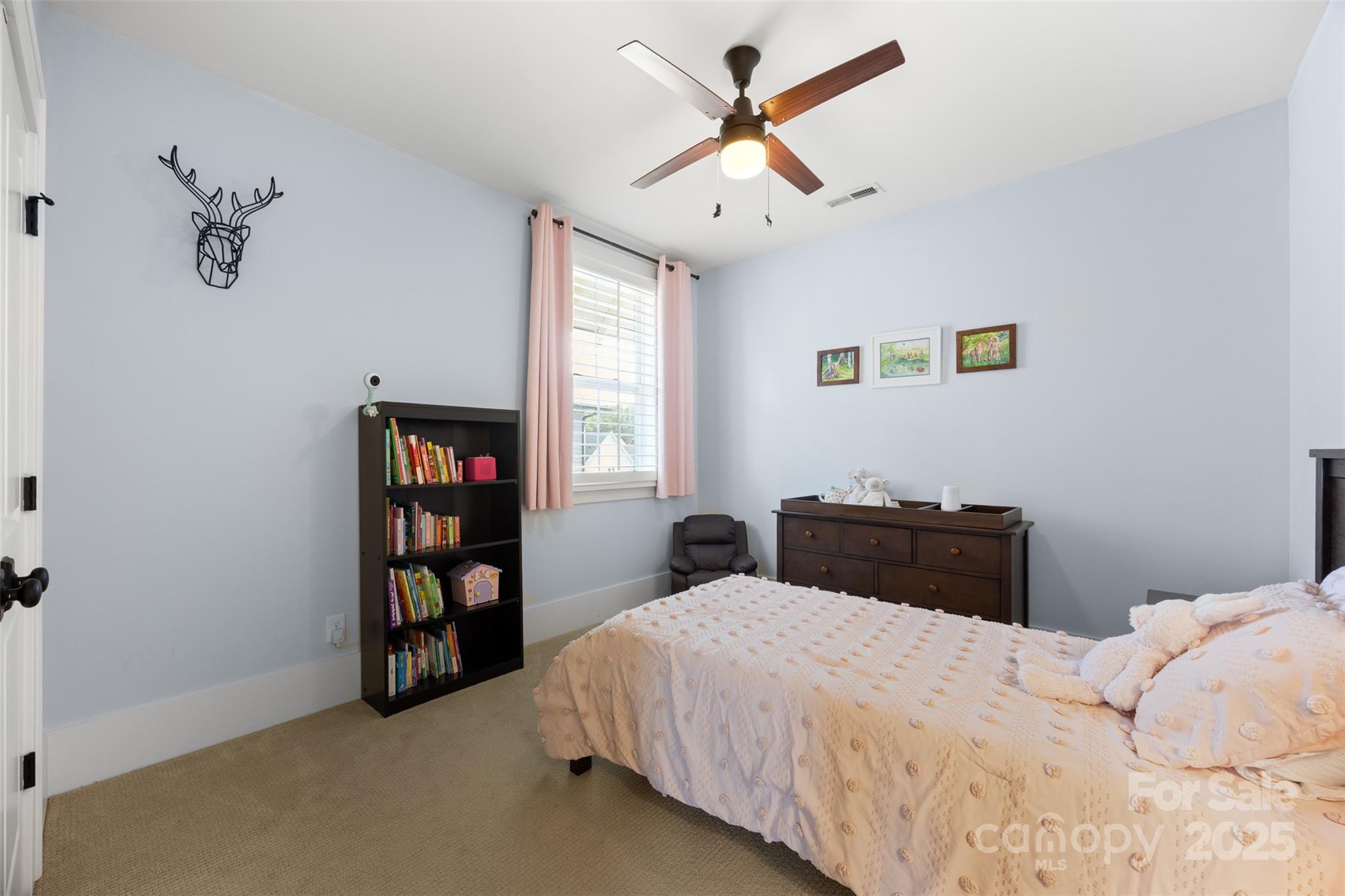 135 Inspired Way Fort Mill, SC 29708 - Photo 34 of 48 a bedroom with a bed and a book shelf