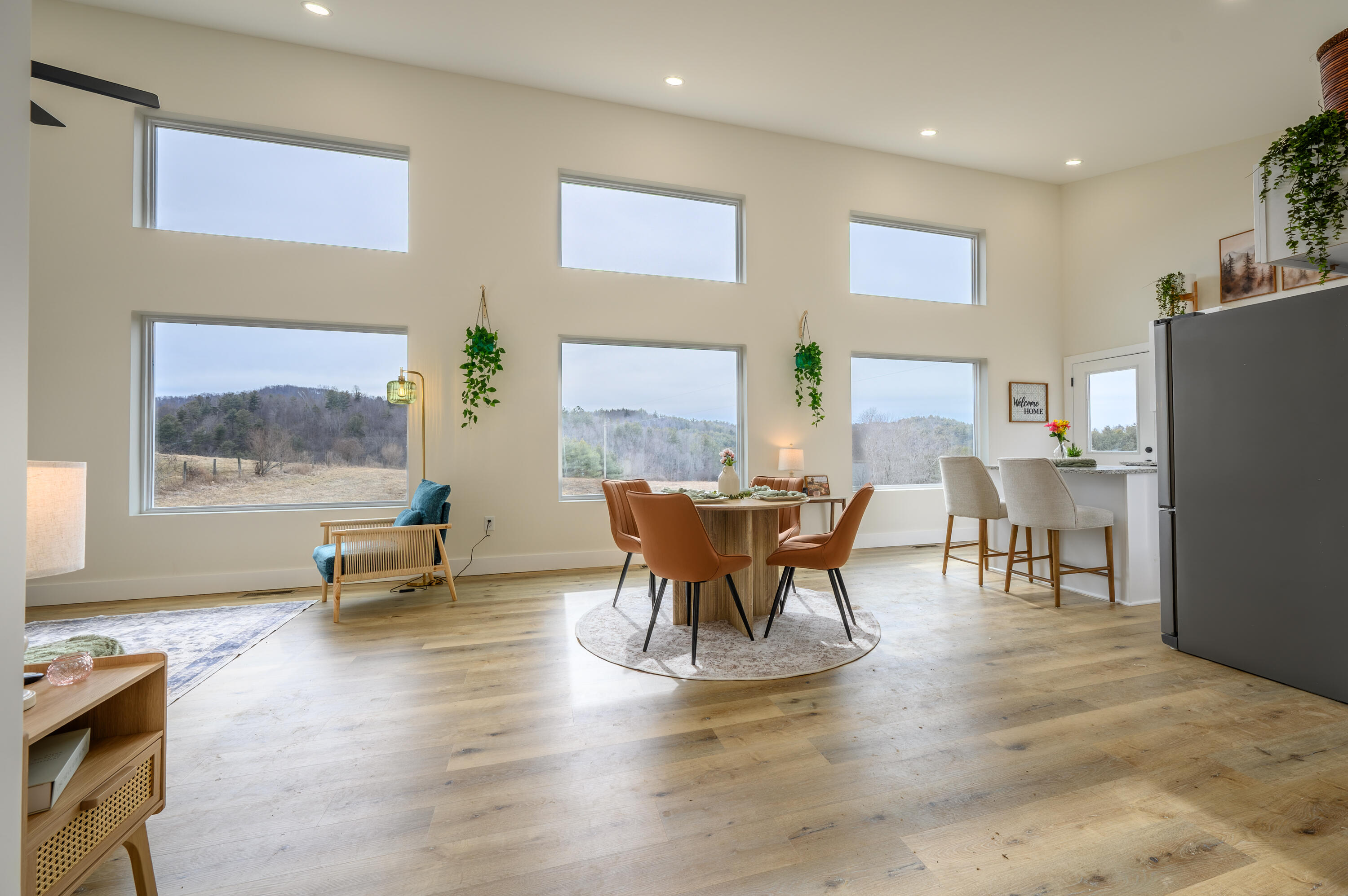 320 Grace Lane Northeast Riner, VA 24149 - Photo 6 of 33 a dining room with furniture a floor to ceiling window and wooden floor
