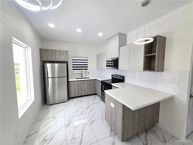 a kitchen with a refrigerator and a sink