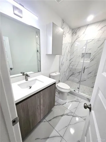 a bathroom with a sink toilet and shower