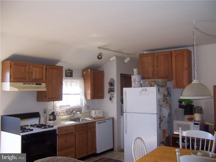 1024 Middle Road Perkasie, PA 18944 - Photo 8 of 14 a kitchen with refrigerator a stove a sink dishwasher and white cabinets with wooden floor