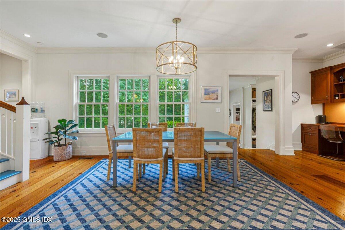 203 Riverside Avenue Riverside, CT 06878 - Photo 15 of 40 a dining room with wooden floor a chandelier a glass table and chairs