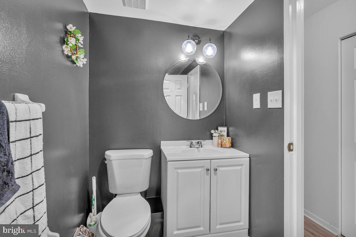 46202 Delaire Landing Road, Unit 202 Philadelphia, PA 19114 - Photo 17 of 34 a bathroom with a toilet a sink and mirror