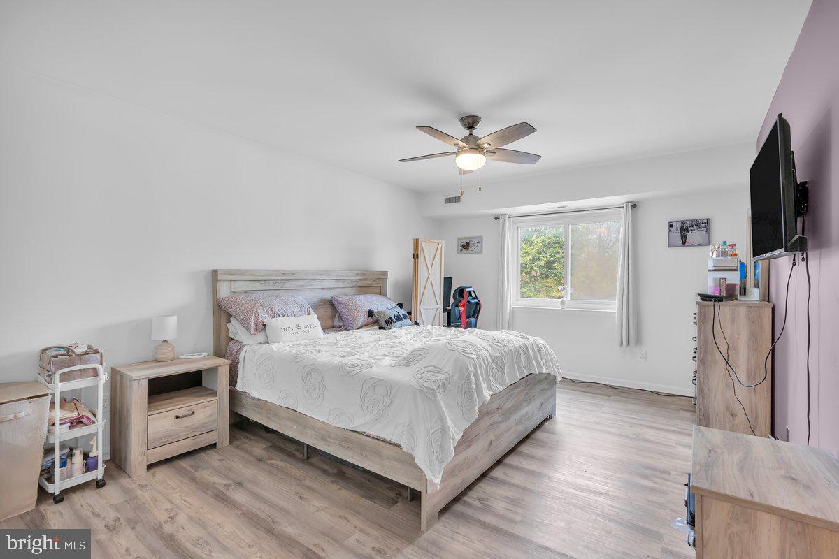46202 Delaire Landing Road, Unit 202 Philadelphia, PA 19114 - Photo 19 of 34 a bedroom with a bed and a flat screen tv
