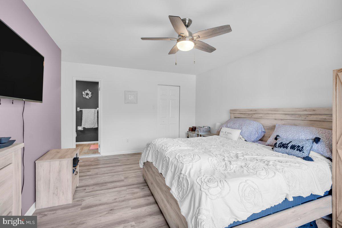 46202 Delaire Landing Road, Unit 202 Philadelphia, PA 19114 - Photo 20 of 34 a bedroom with a bed and a flat screen tv