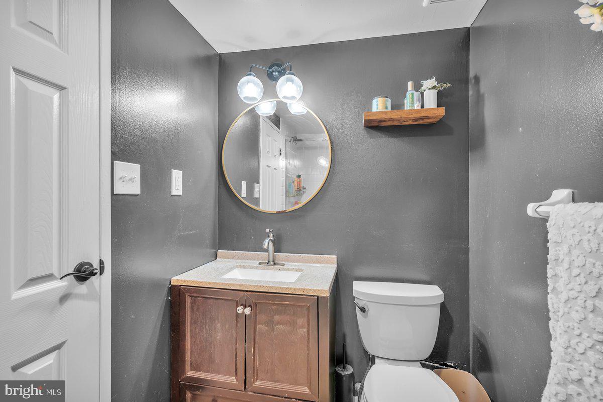 46202 Delaire Landing Road, Unit 202 Philadelphia, PA 19114 - Photo 21 of 34 a bathroom with a toilet a sink and mirror