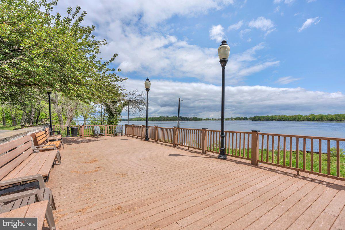 46202 Delaire Landing Road, Unit 202 Philadelphia, PA 19114 - Photo 25 of 34 a view of ocean with a bench in patio