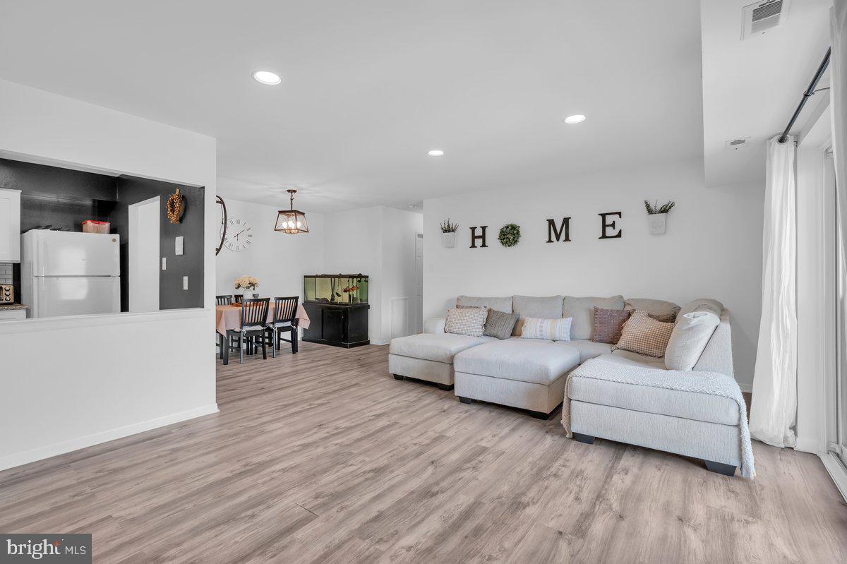 46202 Delaire Landing Road, Unit 202 Philadelphia, PA 19114 - Photo 6 of 34 a living room with furniture and wooden floor