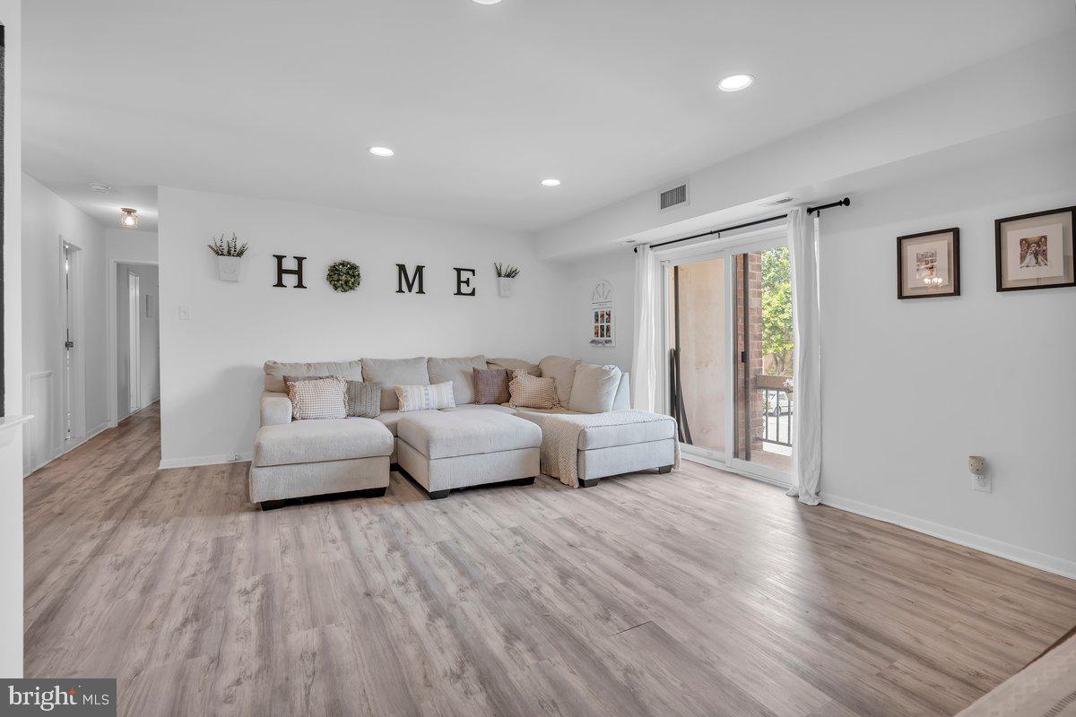 46202 Delaire Landing Road, Unit 202 Philadelphia, PA 19114 - Photo 7 of 34 a living room with furniture and a wooden floor