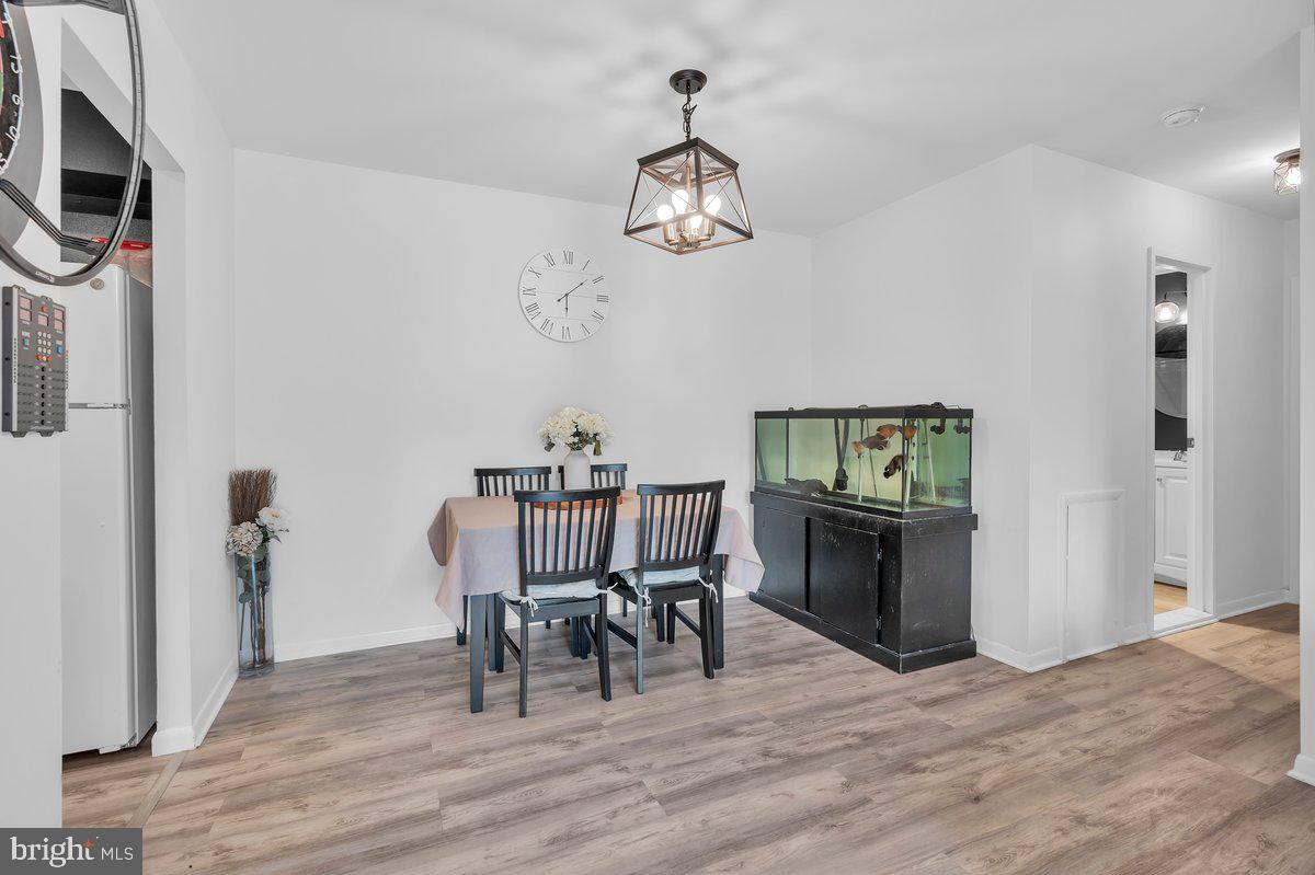 46202 Delaire Landing Road, Unit 202 Philadelphia, PA 19114 - Photo 9 of 34 a view of a dining room with furniture and wooden floor