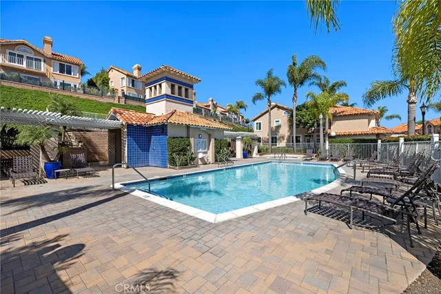 a swimming pool with outdoor seating yard and barbeque oven