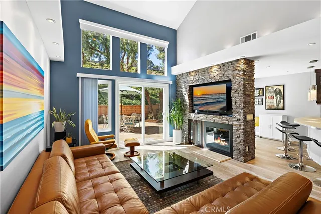 a living room with fireplace furniture and a flat screen tv