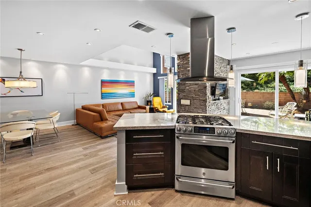 a kitchen with stainless steel appliances granite countertop a stove and a sink