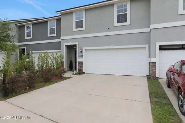 a front view of a house with a yard and garage