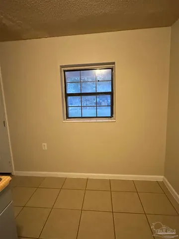 a view of a kitchen with white walls