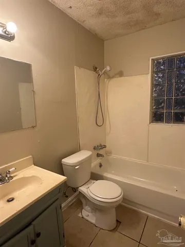 a bathroom with a toilet a sink and shower