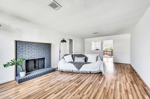 a living room with furniture and wooden floor