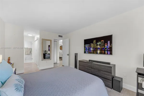 a bedroom with furniture and a flat screen tv