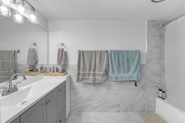 a bathroom with double vanity and a mirror