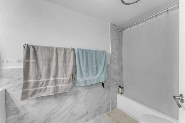 a bathroom with a bathtub and shower