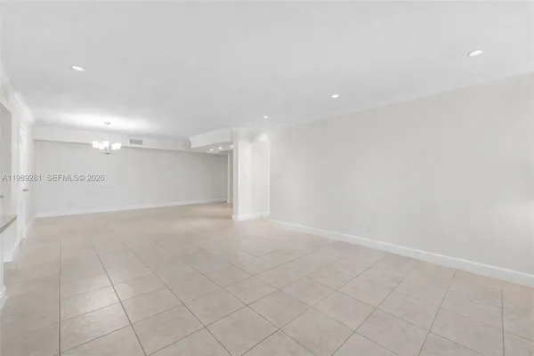 an empty room with white walls and tiles