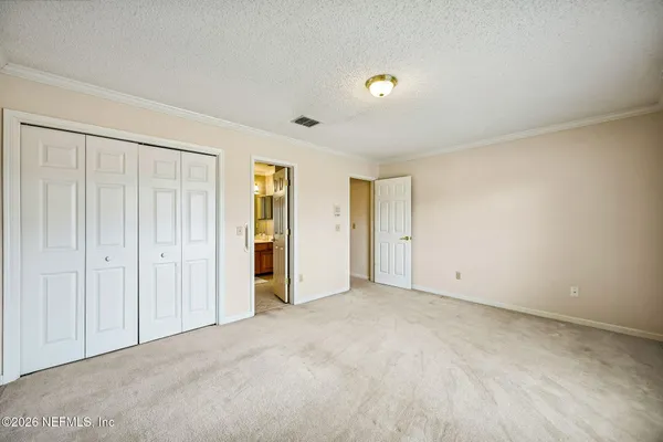 an empty room with closet area