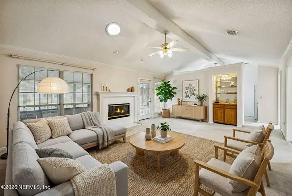 a living room with furniture fireplace and a table