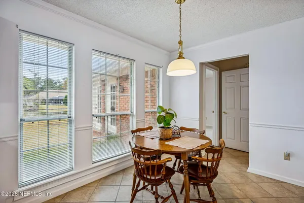 a dining room with furniture and window