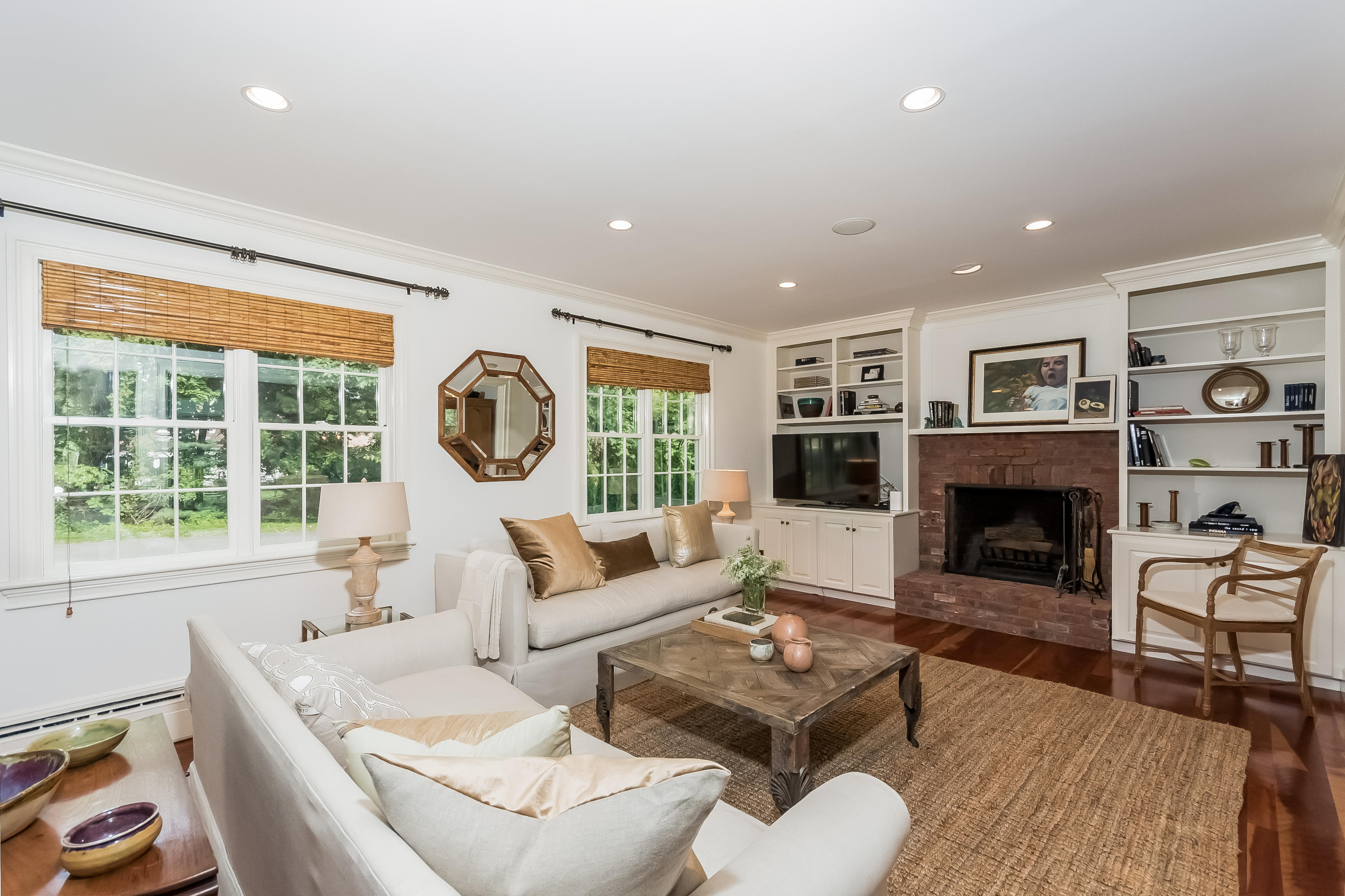 8 Laforge Road Darien, CT 06820 - Photo 17 of 34 a living room with furniture a fireplace and a large window