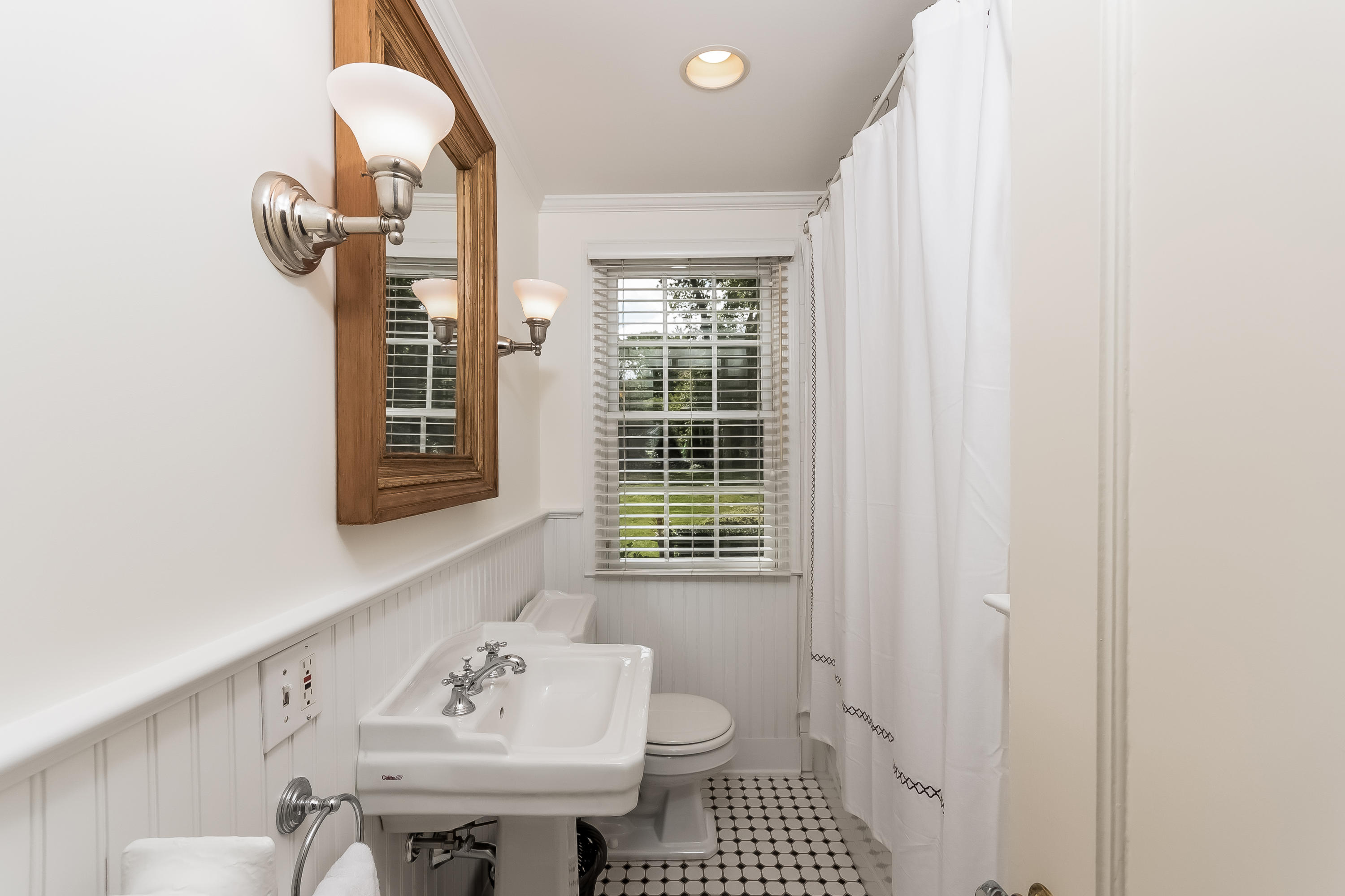 8 Laforge Road Darien, CT 06820 - Photo 19 of 34 a bathroom with a sink a toilet and a window