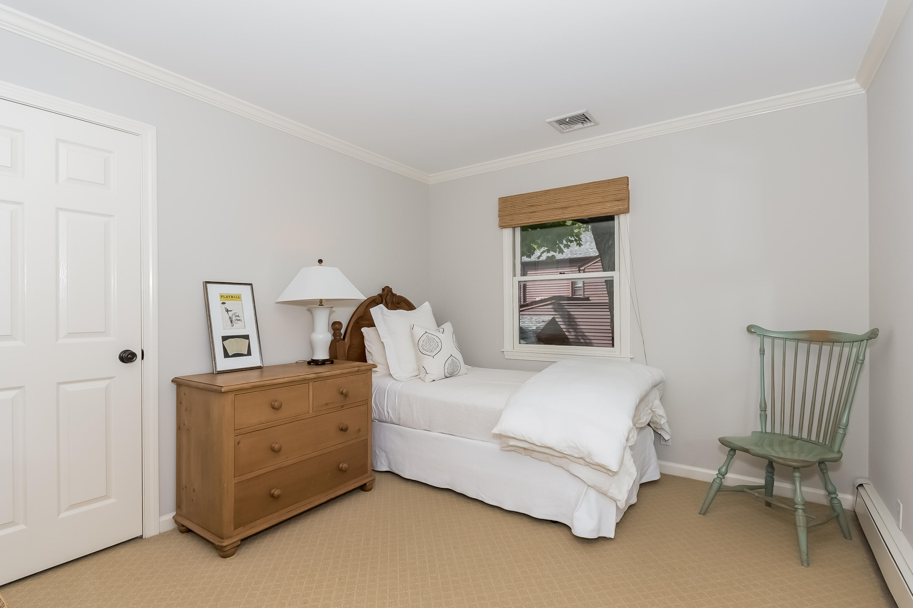 8 Laforge Road Darien, CT 06820 - Photo 30 of 34 a bedroom with a bed and a chair