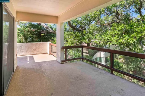 a view of a green field with a tree in the background