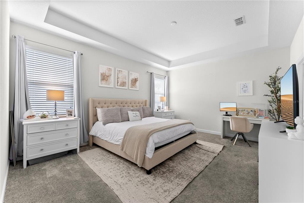2926 Wordsmith Road Kissimmee, FL 34746 - Photo 26 of 42 a bedroom with a bed and a flat screen tv