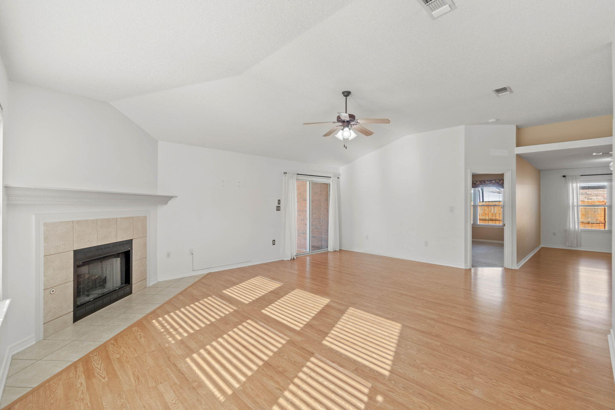 3128 Border Creek Drive Crestview, FL 32539 - Photo 7 of 23 a view of an empty room with wooden floor fireplace and a window