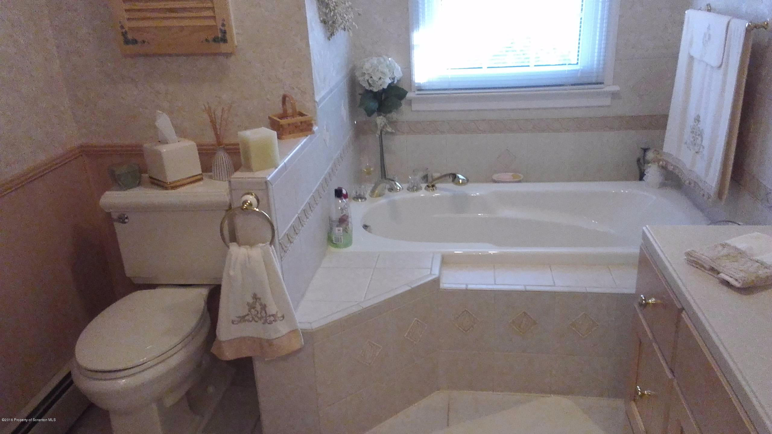 3225 Major Road Moscow, PA 18444 - Photo 13 of 27 a bathroom with a sink and a toilet