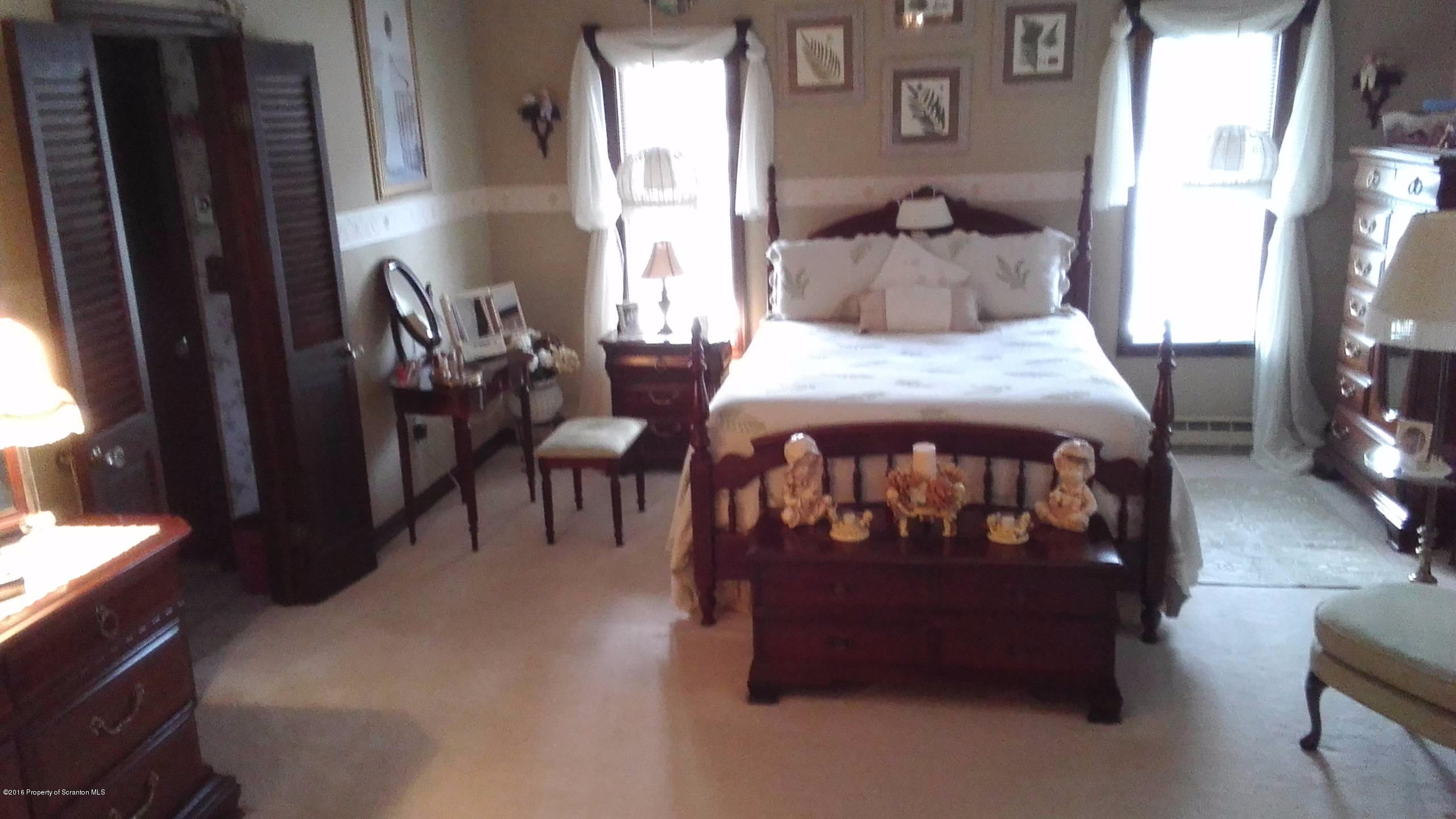3225 Major Road Moscow, PA 18444 - Photo 16 of 27 a bed sitting in a bedroom next to a window