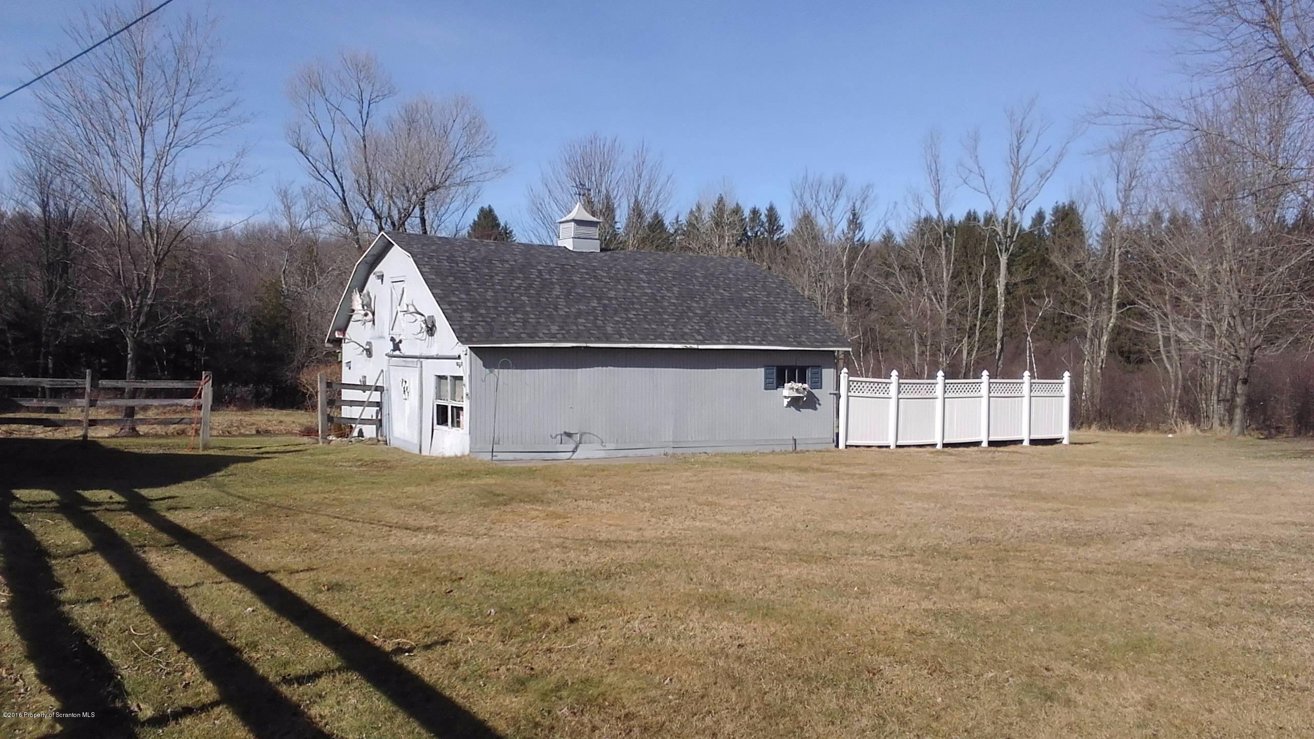3225 Major Road Moscow, PA 18444 - Photo 24 of 27 a view of white house with a yard and covered with snow