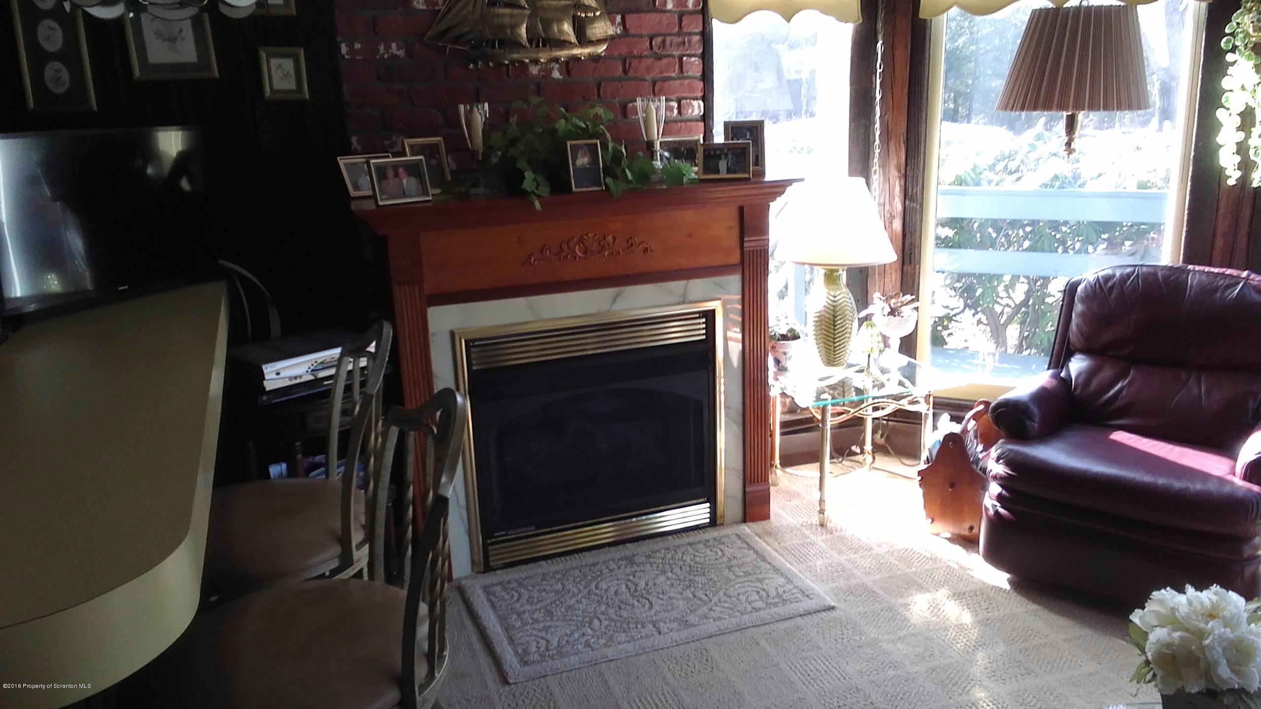 3225 Major Road Moscow, PA 18444 - Photo 7 of 27 a living room with furniture a large window and a fireplace