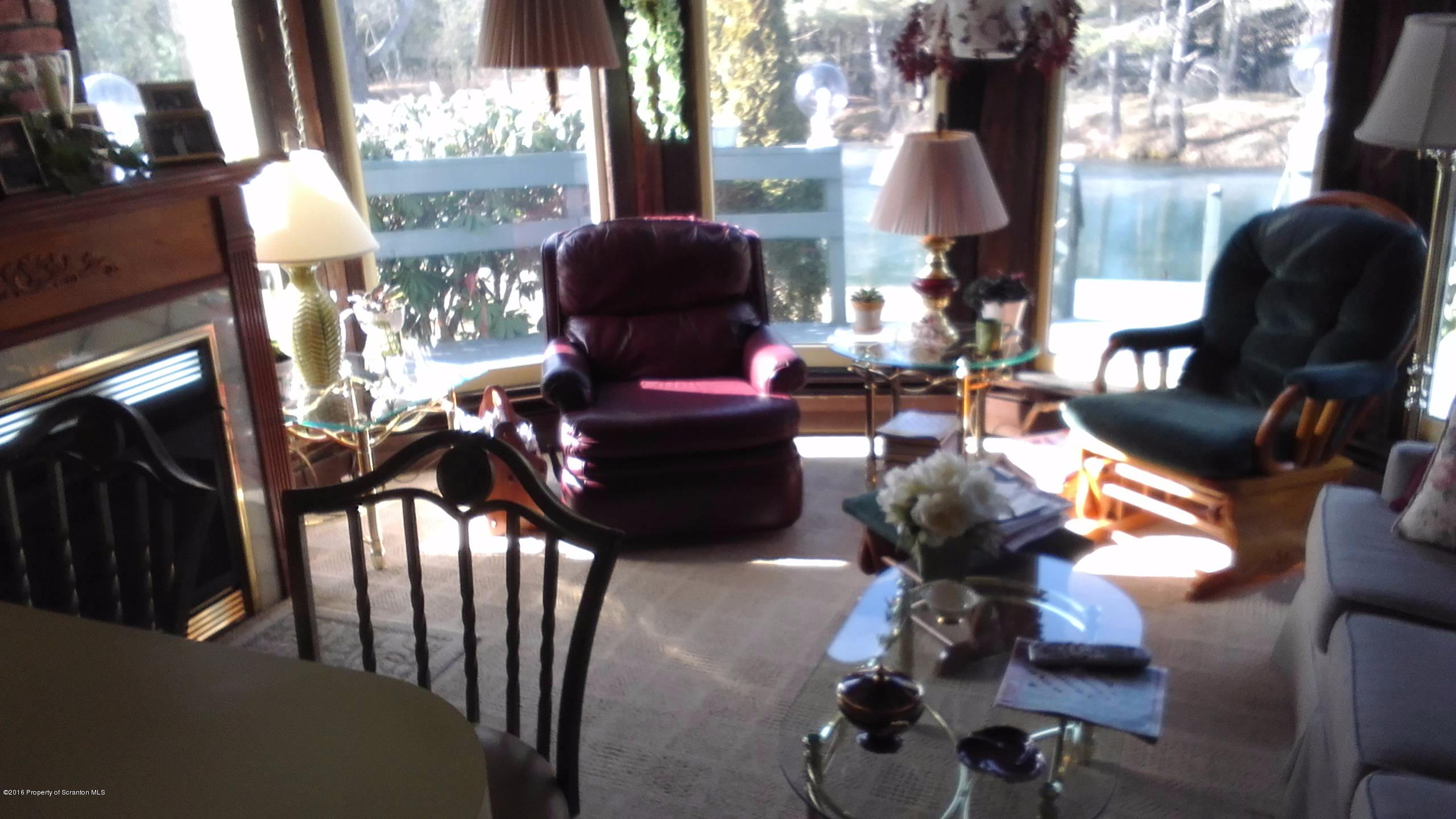3225 Major Road Moscow, PA 18444 - Photo 8 of 27 a living room with furniture and a floor to ceiling window
