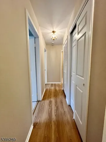 a view of a hallway with wooden floor