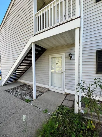 a view of a house with wooden fence