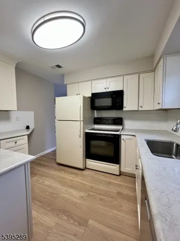 a kitchen with a refrigerator stove and microwave