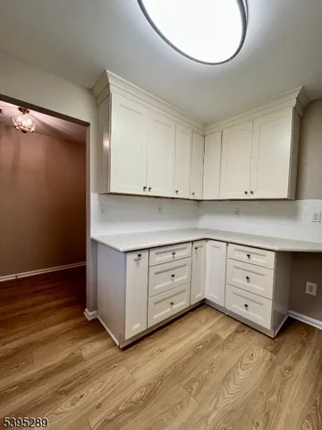 a kitchen with granite countertop white cabinets and white appliances
