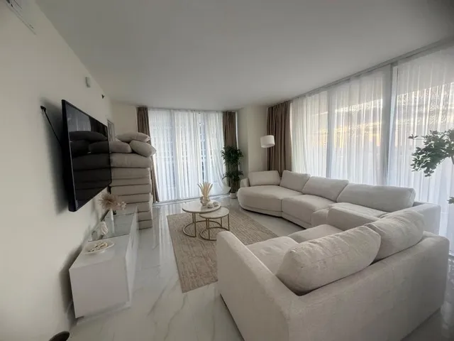a living room with furniture and a flat screen tv