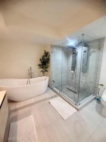 a bathroom with a bathtub and a shower