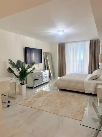 a spacious bedroom with a bed and a couch