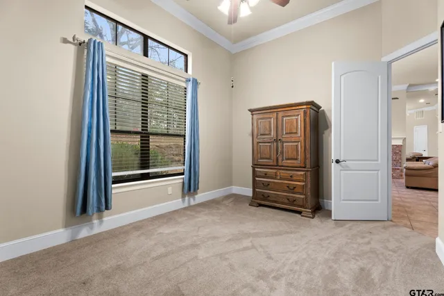 a view of an empty room with closet and cabinet
